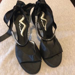 Black heels with rhinestone ribbons around ankle